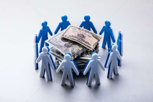 Stacked Banknotes Surrounded By Human Figures Stock photo © AndreyPopov