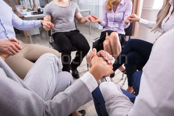 Pessoas do grupo de mãos dadas sessão círculo negócio escritório Foto stock © AndreyPopov