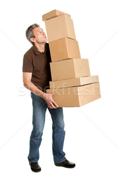 Stock photo: Delivery man balancing stack of boxes