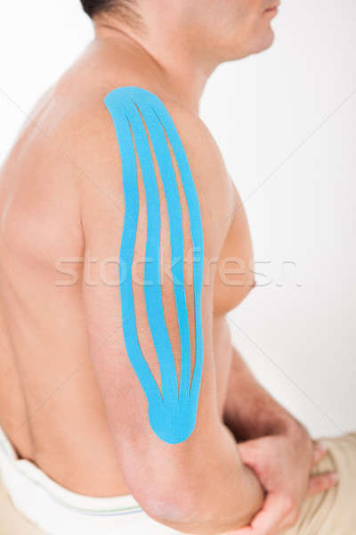 Young Man With Kinesio Tape Applied On Shoulder Stock photo © AndreyPopov