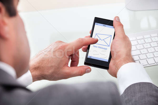 Businessman Holding Mobile With New Message On A Screen Stock photo © AndreyPopov