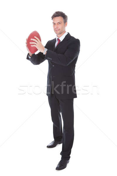 Businessman Holding Rugby Ball Stock photo © AndreyPopov