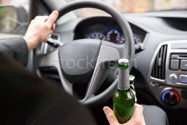 Man Holding Beer Bottle While Driving Stock photo © AndreyPopov