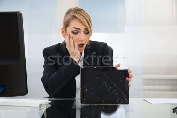 Businesswoman Holding Broken Digital Tablet Stock photo © AndreyPopov