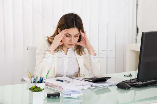 Stock photo: Depressed Businesswoman Calculating Invoice