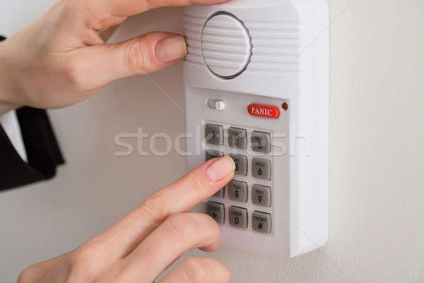 Woman Hand Pressing Button On Security System Stock photo © AndreyPopov