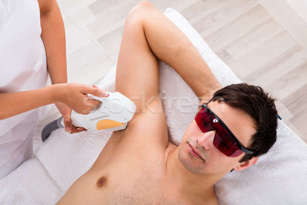 Therapist Giving Laser Epilation Treatment On Man's Armpit Stock photo © AndreyPopov