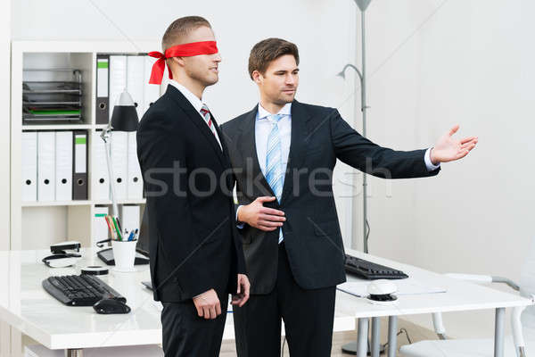 Businessman Assisting Blindfolded Partner Stock photo © AndreyPopov