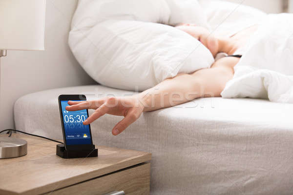 Sleepy Woman Snoozing Alarm On Phone Stock photo © AndreyPopov