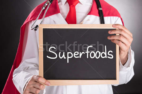 Superhero Doctor Holding Small Chalkboard Stock photo © AndreyPopov