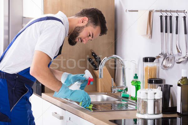 Man Cleaning Kitchen Worktop Stock photo © AndreyPopov