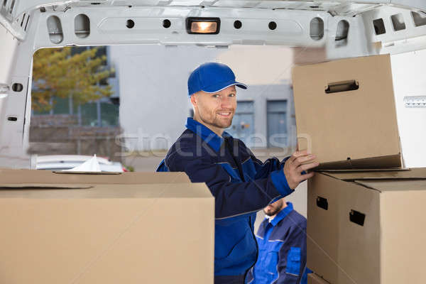 Mover Unloading Cardboard Box From Truck Stock photo © AndreyPopov