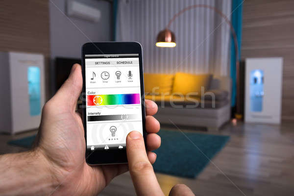 Stockfoto: Menselijke · hand · elektrische · licht · mobiele · telefoon · home