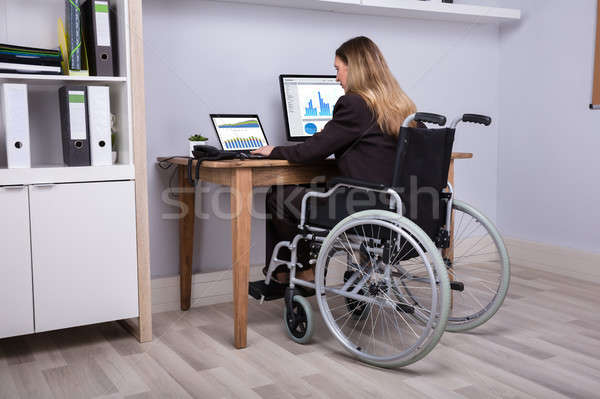 Stock photo: Disabled Businesswoman Working On Computer