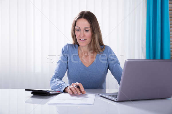 Businesswoman Working In Office Stock photo © AndreyPopov