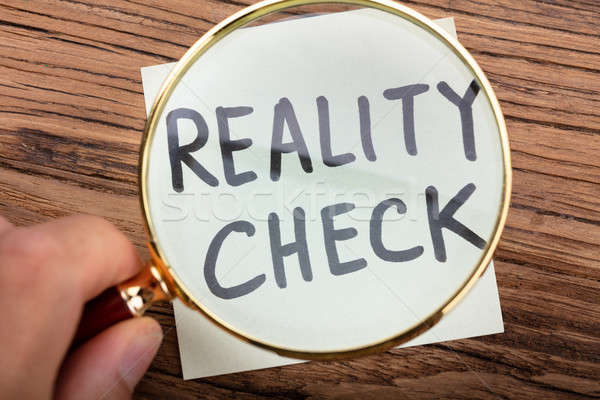 Looking At Reality Check Word Through Magnifying Glass Stock photo © AndreyPopov