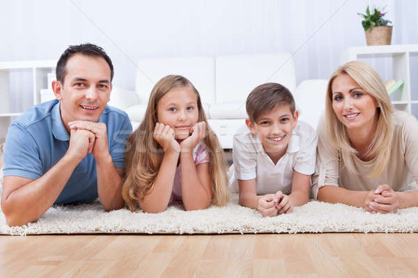 Portrait Of Happy Laying On Carpet Stock photo © AndreyPopov