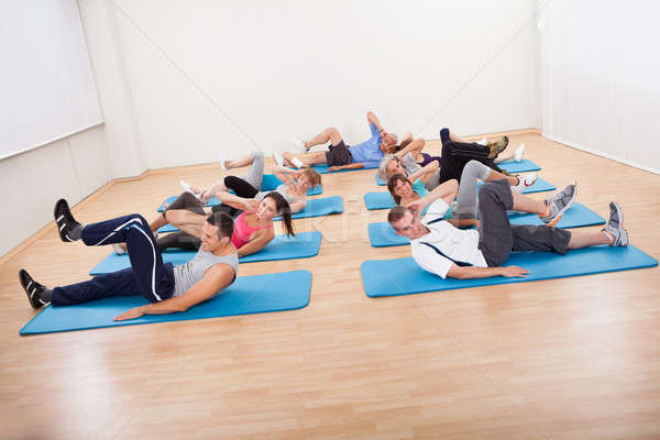 Group of people exercsning in a gym class Stock photo © AndreyPopov