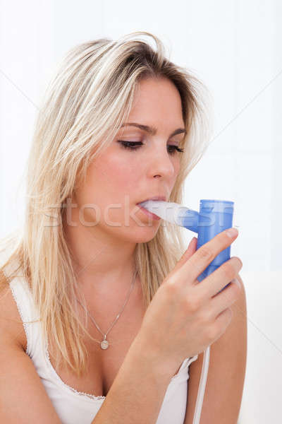 Woman with asthma inhaler Stock photo © AndreyPopov