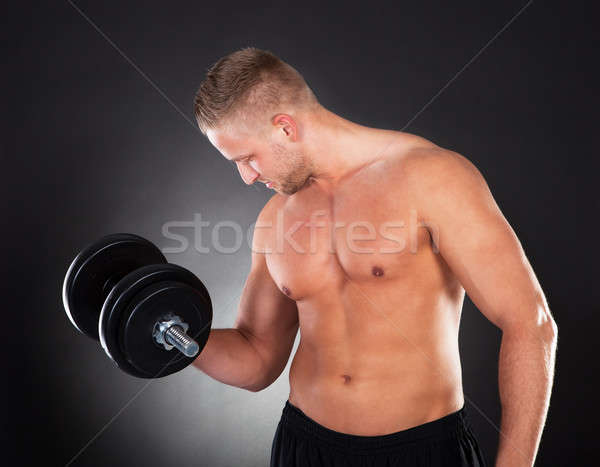 Muscular Man Lifting Weights In A Gym Stock Photo C Andreypopov Stockfresh