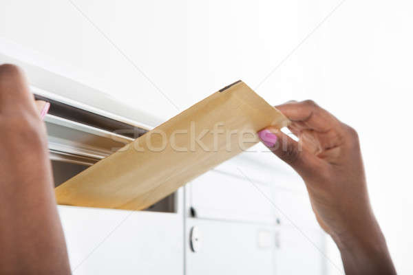 Stock photo: Woman Putting Letters In Mailbox