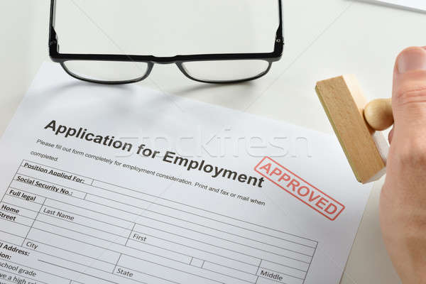 Hand With Rubber Stamp And Approved Employment Application Stock photo © AndreyPopov