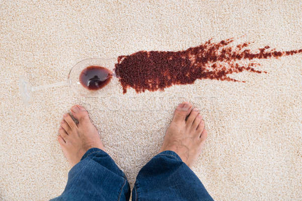Person Standing Near Wine Spilled On Carpet Stock photo © AndreyPopov