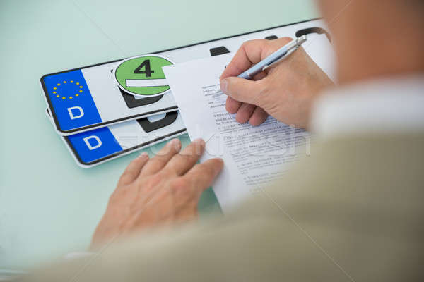 Businessman Filling Car Sale Contract Form Stock photo © AndreyPopov