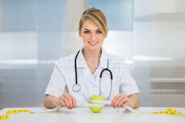 Female Dietician Measuring Green Apple Stock photo © AndreyPopov