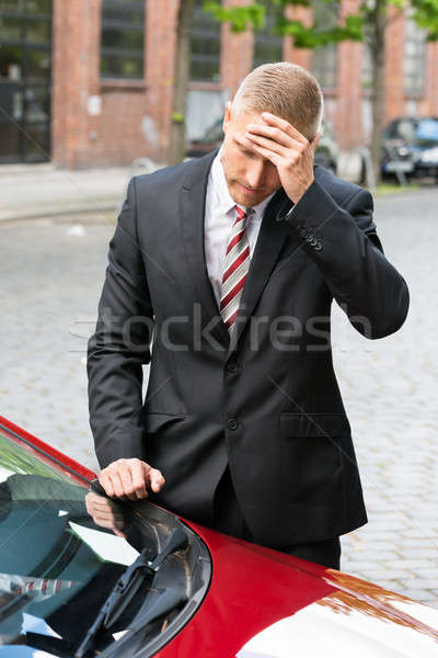 Sad Driver Looking At Parking Ticket On Car Stock photo © AndreyPopov