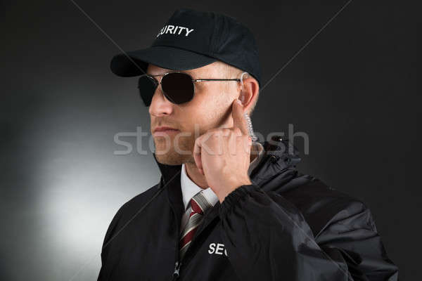 Secret Agent Listening To Earpiece Stock photo © AndreyPopov