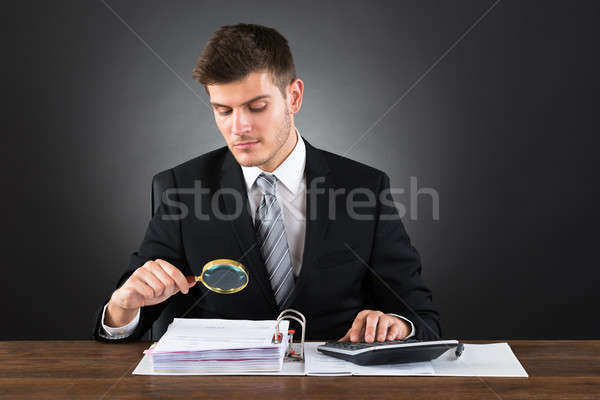 Businessman Scrutinizing Invoice Stock photo © AndreyPopov