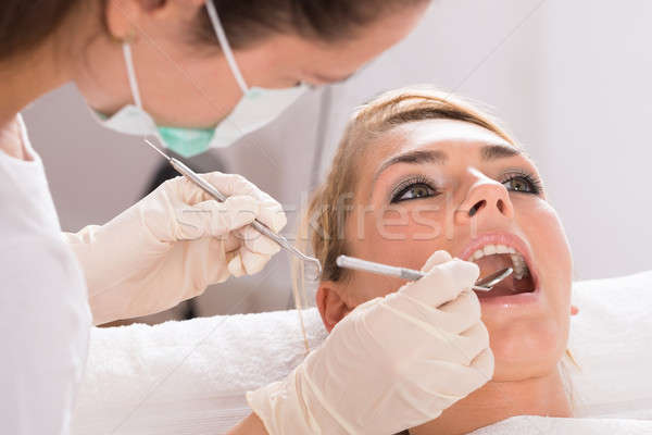 Patient Getting Dental Checkup At Clinic Stock photo © AndreyPopov