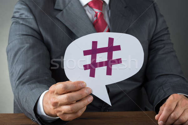 Businessman Showing Hashtag On Speech Bubble Stock photo © AndreyPopov