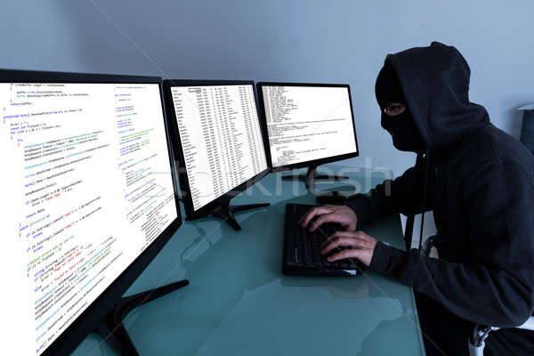 Hacker Stealing Data On Multiple Computers Stock photo © AndreyPopov