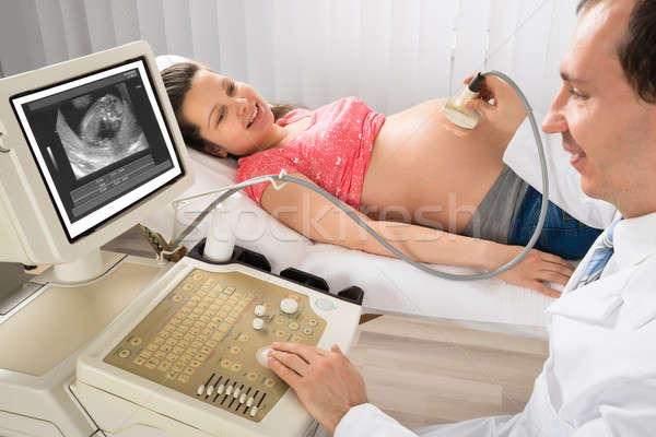 Doctor Moving Ultrasound Transducer On Pregnant Woman's Belly Stock photo © AndreyPopov