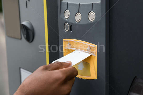 Stock photo: Person's Hand Inserting Ticket Into Parking Machine