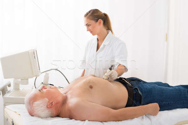 Doctor Using Ultrasound Scan On Abdomen Of Male Patient Stock photo © AndreyPopov