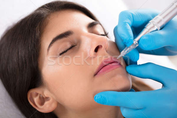 Cosmetologist Applying Permanent Make Up On Lips Stock photo © AndreyPopov