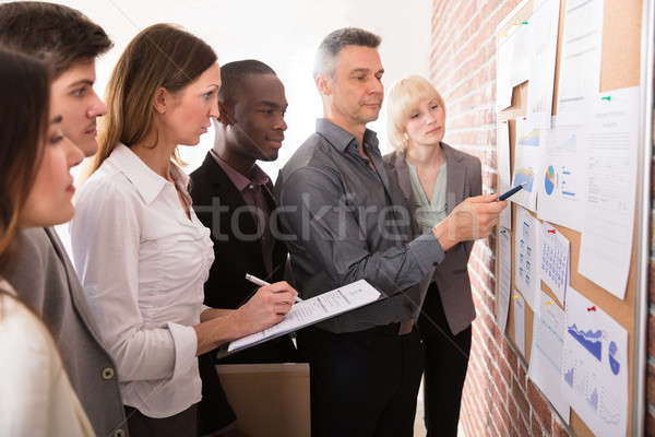 Manager Analyzing The Graph With His Colleague Stock photo © AndreyPopov