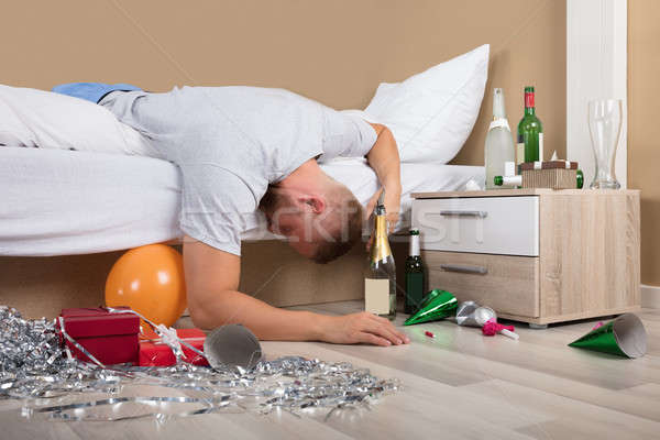 Fáradt férfi ágy buli fiatalember felfelé Stock fotó © AndreyPopov