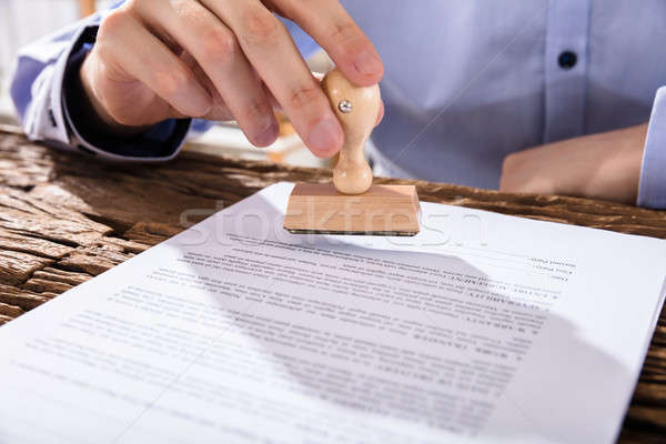Person Holding Stamp On Document Stock photo © AndreyPopov