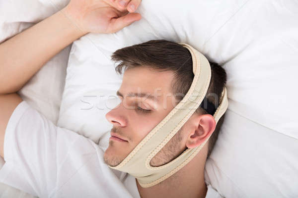 Man Sleeping With Anti Snoring Bandage Stock photo © AndreyPopov