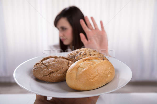Woman Refusing Plate Of Bread And Cookies Stock photo © AndreyPopov