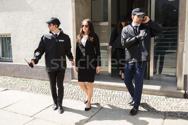 Jóvenes mujer de negocios caminando acera edificio seguridad Foto stock © AndreyPopov