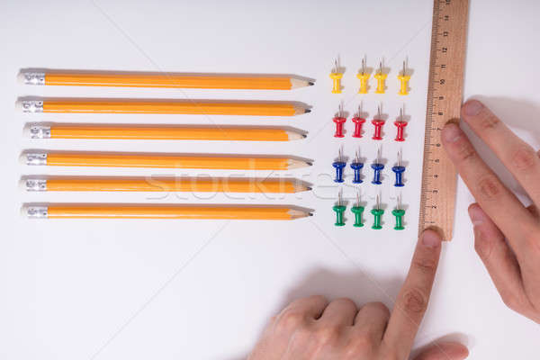 Person's Hand Arranging Pencils And Multi Colored Pushpins Stock photo © AndreyPopov
