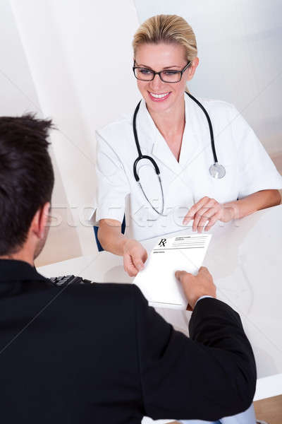 Female doctor consulting with a patient Stock photo © AndreyPopov