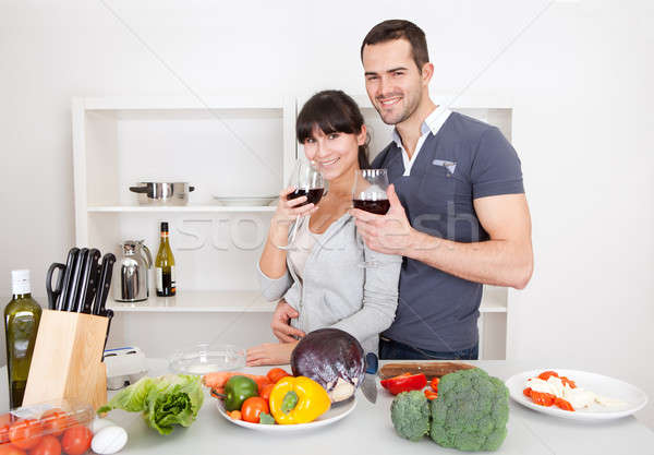 Stock photo: Young couple cooking at home