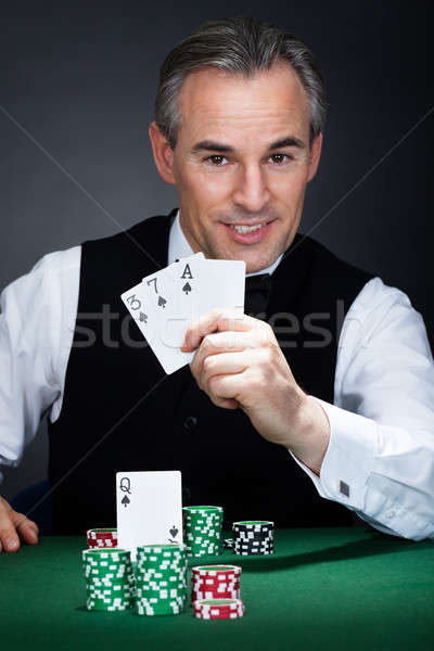 Croupier holding playing cards Stock photo © AndreyPopov