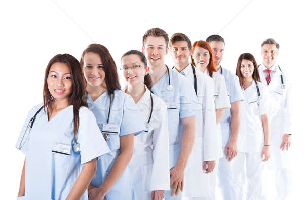 Stock photo: Long line of smiling doctors and nurses
